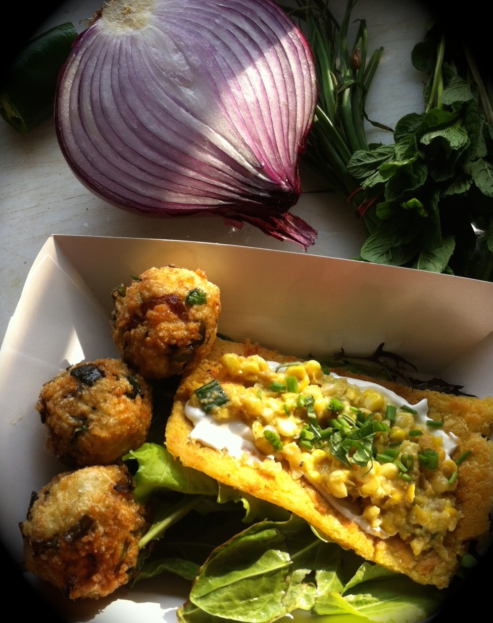 the food:&nbsp; calas&nbsp; aka rice balls with fresh herbs, red onion and sardines &amp;&nbsp; farinata , a chickpea flatbread with feta cheese spread, grilled onions, creamed corn, capers and chives {on a bed of Brother Nature greens}